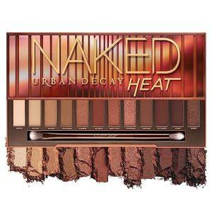 An eyeshadow with earth colors or different shades of brown with an eye shadow brush.